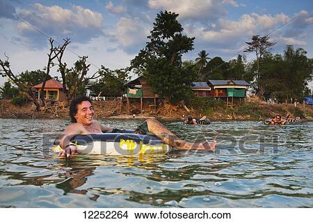 Tubing in the Mekong River; Si Phan Don, Laos View Large Photo Image Picture - Tubing in the Mekong River; Si Phan Don, Laos. Fotosearch
