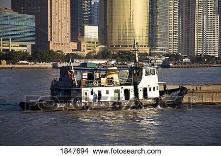 Tugboat & Barge On Huangpu River In The Bund Area; Shanghai, China View Large Photo Image Picture - Tugboat & Barge On Huangpu River In The Bund Area; Shanghai, China. Fotosearch