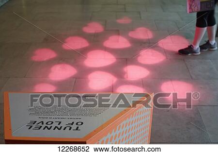Stock Image - Tunnel of Love Exhibition, pink hearts projected on the floor; London, England. Fotosearch