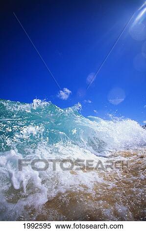 Stock Photography - Turbulent Shoreline Break Water, Sun Rays In Clear Blue Sky.. Fotosearch