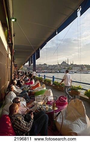 Stock Image - Turkey, Bars along bottom of Galata Bridge at dusk; Istanbul. Fotosearch