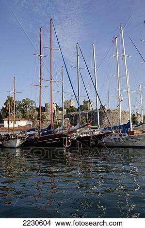 Picture - Turkey, Behind Is Bodrum Castle; Bodrum, Gulet Boats Lined Up In Harbour Of Bodrum Bay. Fotosearch