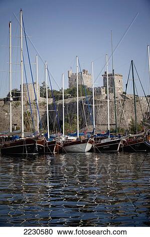 Stock Image - Turkey, Behind Is Bodrum Castle; Bodrum, Gulet Boats Lined Up In Harbour Of Bodrum Bay. Fotosearch