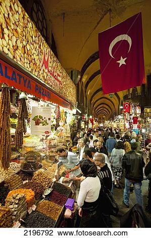 Stock Image - Turkey, Egyptian Bazaar; Istanbul, People buying dried fruit and nuts from stall. Fotosearch