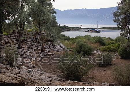 Stock Image - Turkey, Gokava Gulf, Behind Cleopatra Beach; Sedir (Cedrai) Island, Gulet Boat Seen From Ruins Of Amphitheater. Fotosearch