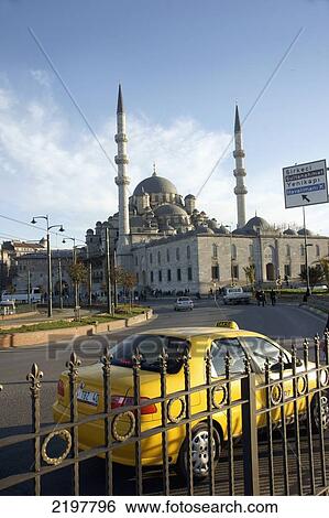 Stock Photograph - Turkey, Istanbul, Exterior Of Mosque Yeni Camii(1597) And Yellow Taxi; Eminonou. Fotosearch