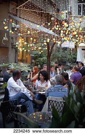 Stock Photography - Turkey, Istanbul, People Relaxing In Cafe At Sofyali Sokak; Beyoglu District. Fotosearch