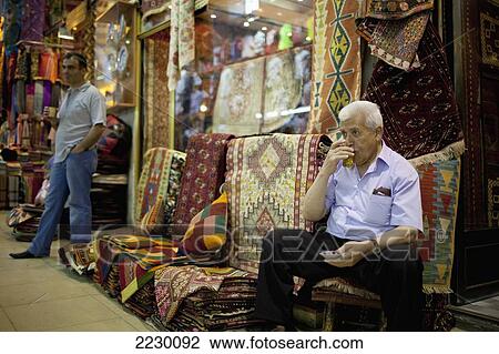 Stock Image - Turkey, Istanbul, Traditional Drink In Turkey Served In Glass Cups In Kapali Carsi (Grand Bazaar); Beyazit, Carpet Sellers Stop For Tea. Fotosearch