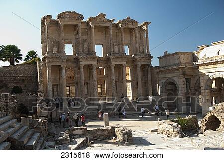 Stock Photo - Turkey, Izmir Province, Ephesus, People walking in front of Celsus Library and Gate of Mazeus and Mithridates. Fotosearch