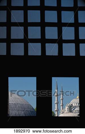 Stock Image - Turkey, Looking out window and across domed roofs of Haghia Sophia to Sultanahmet or Blue Mosque; Istanbul. Fotosearch