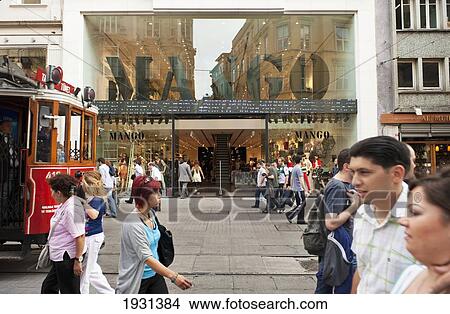 Picture - Turkey, People and Traditional Tram passing store on Istiklal Caddesi; Istanbul. Fotosearch