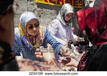 Stock Photo - Turkey, Women In Headscarves Selling Home Made Traditional Foods At Carsamba Pazari; Istanbul. Fotosearch