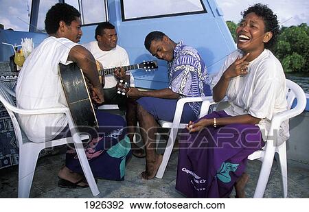 Stock Image - Turtle Island Resort Staff Relaxing And Playing Music. Fotosearch