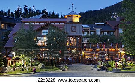 Stock Photo - Twilight descends upon Dusty's Bar & BBQ at the base of Whistler Mountain; Whistler, British Columbia, Canada. Fotosearch