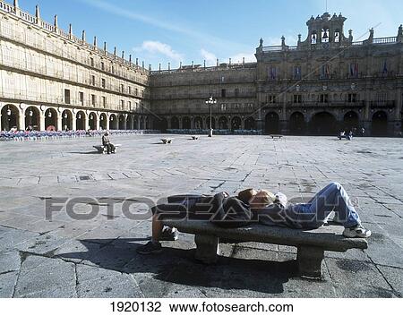Stock Image - Two Backpackers Resting In Sun, Plaza Mayor. Fotosearch