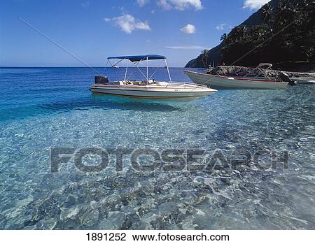 Stock Image - Two Boats Floating On Ocean. Fotosearch