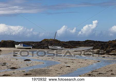 Stock Image - Two Boats On The Beach; Sanna Ardnamurchan Argyl Scotland. Fotosearch