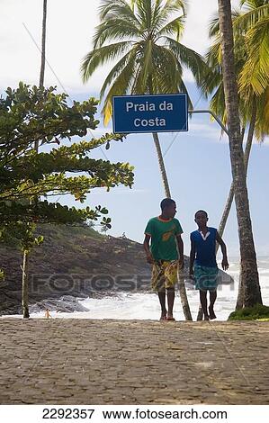 Two boys walking along beach, Praia Da Costa; Itacare, Bahia State, Brazil View Large Photo Image Stock Photo - Two boys walking along beach, Praia Da Costa; Itacare, Bahia State, Brazil. Fotosearch