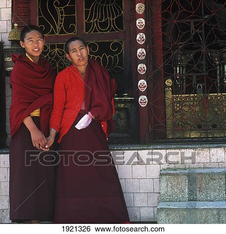Stock Photograph - Two Buddhist Monks At Shrine. Fotosearch