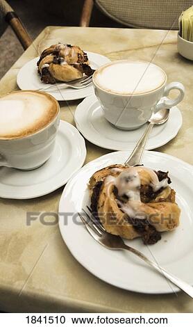 Stock Image - Two Cappucinos And Dessert On Table In Cafe; Verona, Italy. Fotosearch