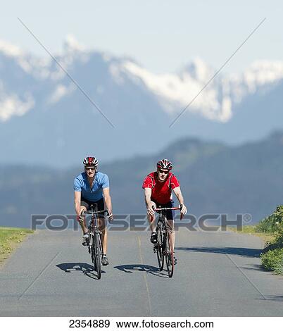 Two Caucasian Men Cycling On Road Bicycles; Vancouver Island, British Columbia, Canada View Large Photo Image Stock Photo - Two Caucasian Men Cycling On Road Bicycles; Vancouver Island, British Columbia, Canada. Fotosearch