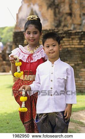 Two children dressed formally for a Buddhist ceremony; Thailand View Large Photo Image Stock Image - Two children dressed formally for a Buddhist ceremony; Thailand. Fotosearch