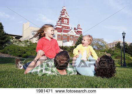 Two Daughters Play With Parents In Grass; Bellingham Washington United States Of America View Large Photo Image Stock Image - Two Daughters Play With Parents In Grass; Bellingham Washington United States Of America. Fotosearch