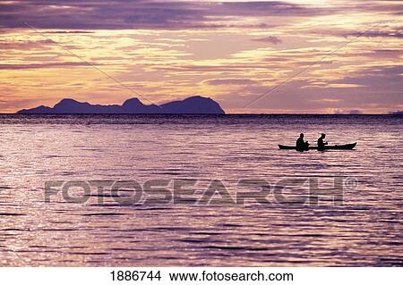 Picture - Two Fishermen Rowing In A Canoe. Fotosearch