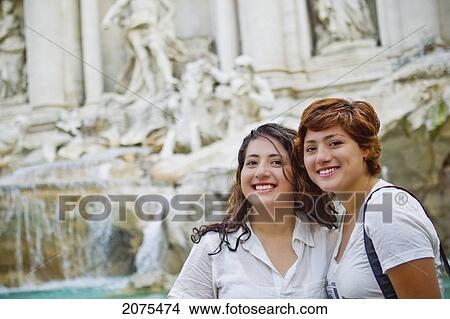 Picture - Two Friends Posing In Front Of Trevi Fountain; Rome Italy. Fotosearch