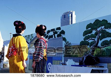 Two Geishas Dressed In Kimonos In Front Of Modern Building View Large Photo Image Stock Image - Two Geishas Dressed In Kimonos In Front Of Modern Building. Fotosearch