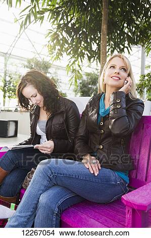 Two girlfriends out shopping together and taking a rest; St. Albert, Alberta, Canada View Large Photo Image Picture - Two girlfriends out shopping together and taking a rest; St. Albert, Alberta, Canada. Fotosearch