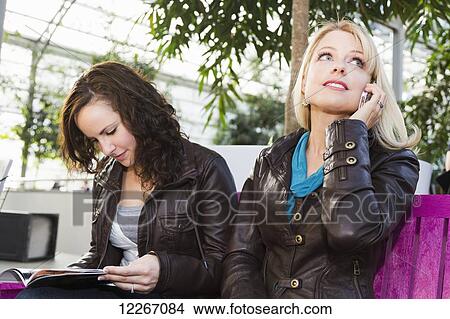 Picture - Two girlfriends out shopping together and taking a rest; St. Albert, Alberta, Canada. Fotosearch