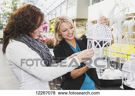 Two girlfriends shopping in a mall together; St. Albert, Alberta, Canada View Large Photo Image Stock Photo - Two girlfriends shopping in a mall together; St. Albert, Alberta, Canada. Fotosearch