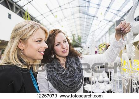 Two girlfriends shopping in a mall together; St. Albert, Alberta, Canada View Large Photo Image Stock Photo - Two girlfriends shopping in a mall together; St. Albert, Alberta, Canada. Fotosearch