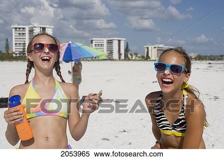 Two Girls On The Beach, Applying Sun Screen, Sarasota, Florida View Large Photo Image Stock Photography - Two Girls On The Beach, Applying Sun Screen, Sarasota, Florida. Fotosearch