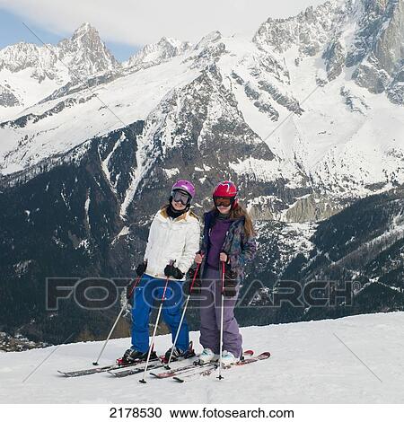 Stock Image - Two Girls Skiing In The French Alps; Chaminox-Mont-Blanc Rhone-Alpes France. Fotosearch