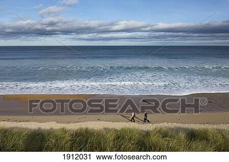 Two Hikers At Embleton Bay, Northumberland, Uk View Large Photo Image Stock Image - Two Hikers At Embleton Bay, Northumberland, Uk. Fotosearch