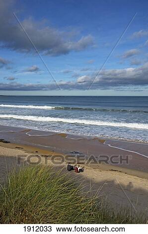 Two Hikers At Embleton Bay, Northumberland, Uk View Large Photo Image Stock Image - Two Hikers At Embleton Bay, Northumberland, Uk. Fotosearch