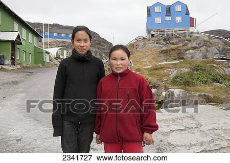 Two Inuit Girls In A Village; Kangaamiut, Greenland View Large Photo Image Stock Photo - Two Inuit Girls In A Village; Kangaamiut, Greenland. Fotosearch
