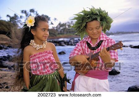 Two Kids On Beach, Boy Plays Ukulele Wearing Fern Haku, Girl Wears Ti Leaf Skirt View Large Photo Image Stock Image - Two Kids On Beach, Boy Plays Ukulele Wearing Fern Haku, Girl Wears Ti Leaf Skirt. Fotosearch