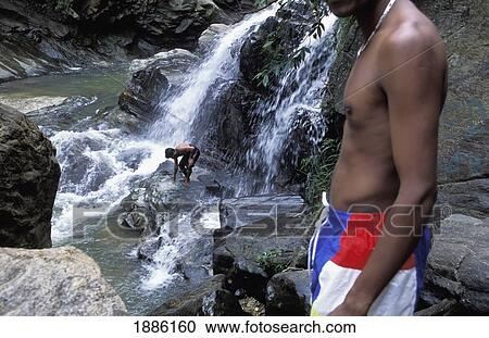 Stock Image - Two Local Men At Ella Waterfall. Fotosearch