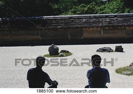 Stock Image - Two Men At Ryoanji Zen Rock Gardens. Fotosearch