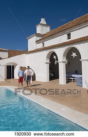 Two Men Beside Swimming Pool; Cazalla De La Sierra, Andalucia, Spain, Europe View Large Photo Image Stock Image - Two Men Beside Swimming Pool; Cazalla De La Sierra, Andalucia, Spain, Europe. Fotosearch