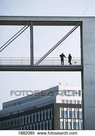 Two Men On Bridge Between Government Buildings Either Side Of River Spree View Large Photo Image Stock Photography - Two Men On Bridge Between Government Buildings Either Side Of River Spree. Fotosearch