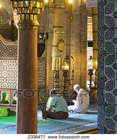 Two Men Quietly Reading In The Interior Of The New Mosque; Istanbul, Turkey View Large Photo Image Stock Photo - Two Men Quietly Reading In The Interior Of The New Mosque; Istanbul, Turkey. Fotosearch