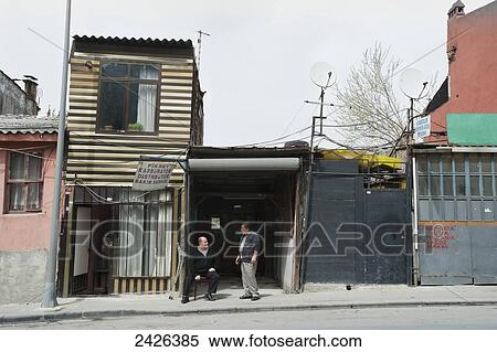 Stock Photography - Two men talking outside old houses; Istanbul, Turkey. Fotosearch