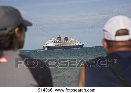 Stock Photograph - Two Men Watching Cruise Ship. Fotosearch