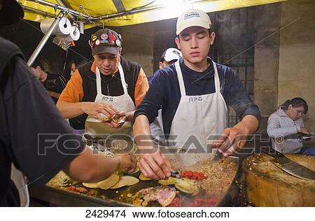 Picture - Two men working at a taco stand; Queretaro, Mexico. Fotosearch