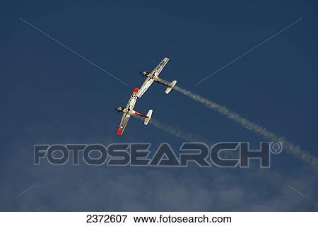 Stock Photo - Two Military Planes In The Blue Sky Flying Side By Side; Locarno, Ticino, Switzerland. Fotosearch