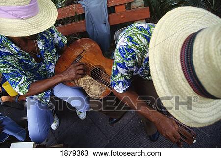 Stock Image - Two Musicians In Straw Hats Holding Guitar. Fotosearch
